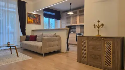 a living room with a couch and a table at Vytauto Apartments in Šiauliai