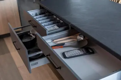a kitchen counter with an open drawer with tools at Modern 2 BDR Apartment next to Vilnius Outlet by URBAN RENT in Vilnius
