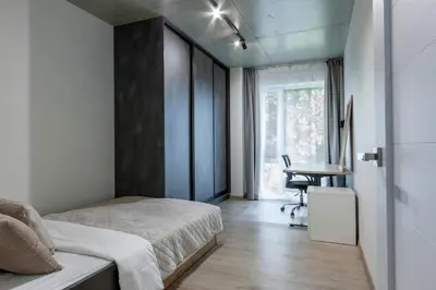 a bedroom with a bed and a desk and a window at Modern 2 BDR Apartment next to Vilnius Outlet by URBAN RENT in Vilnius