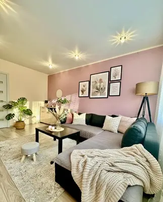 a living room with a couch and a table at Victoria Central Apartamentai in Druskininkai