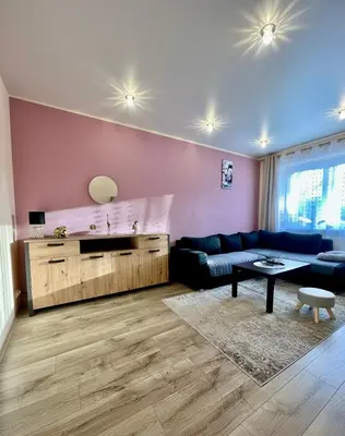 a living room with a couch and a table at Victoria Central Apartamentai in Druskininkai