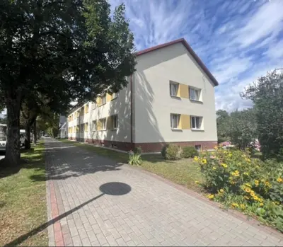 a building on the side of a street at Victoria Central Apartamentai in Druskininkai