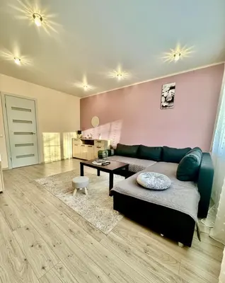 a living room with a couch and a table at Victoria Central Apartamentai in Druskininkai