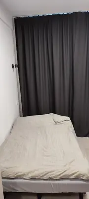 a bed in a room with a black curtain at SimpleStayVilnius in Vilnius
