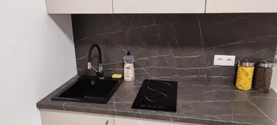 a kitchen counter with a sink and a bottle of soap at SimpleStayVilnius in Vilnius
