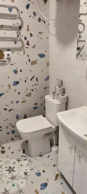 a bathroom with a toilet and a wallpaper with fishes at SimpleStayVilnius in Vilnius