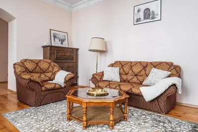 a living room with two couches and a coffee table at Heritage One Bedr Apartment by the Gates of Dawn by Reside Baltic in Vilnius