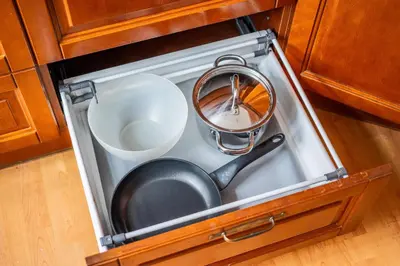 a frying pan and a pot in a drawer at Heritage One Bedr Apartment by the Gates of Dawn by Reside Baltic in Vilnius