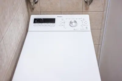 a white washer and dryer in a bathroom at Heritage One Bedr Apartment by the Gates of Dawn by Reside Baltic in Vilnius