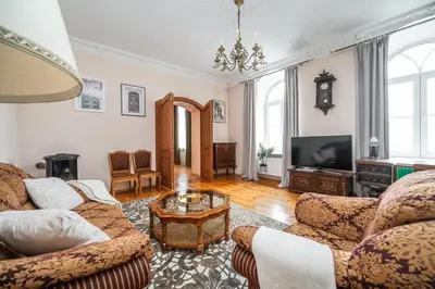 a living room with two couches and a tv at Heritage One Bedr Apartment by the Gates of Dawn by Reside Baltic in Vilnius