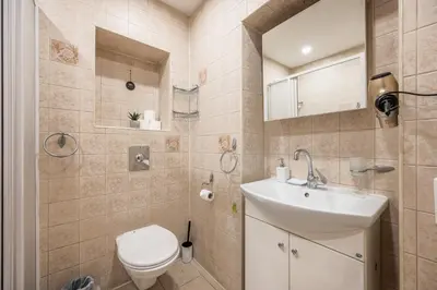 a bathroom with a toilet and a sink at Heritage One Bedr Apartment by the Gates of Dawn by Reside Baltic in Vilnius