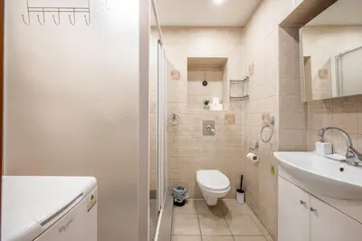 a bathroom with a toilet and a sink and a shower at Heritage One Bedr Apartment by the Gates of Dawn by Reside Baltic in Vilnius