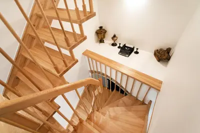 a staircase in a house with wooden floors at Saint John Two Bedroom Cottage by Reside Baltic in Vilnius