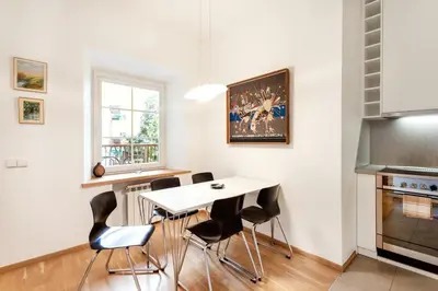 a kitchen with a white table and chairs at Saint John Two Bedroom Cottage by Reside Baltic in Vilnius