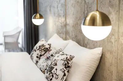 a bedroom with a bed with two pillows and two lights at Superior 2 Bedroom 2 Bathroom Apartment by Reside Baltic in Vilnius