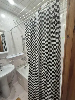a bathroom with a black and white shower curtain at Entrara in VNO