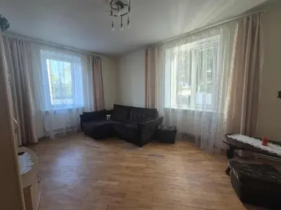 a living room with a couch and two large windows at Entrara in VNO