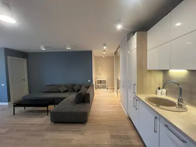 a living room with a couch and a bed at M27 Apartments in Vilnius
