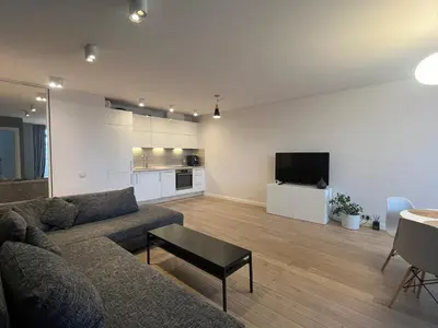 a living room with a couch and a tv at M27 Apartments in Vilnius