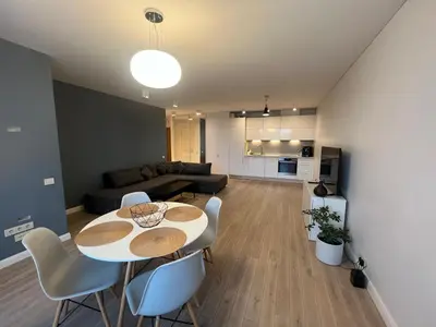 a living room with a table and chairs and a couch at M27 Apartments in Vilnius