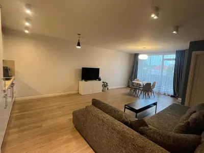a living room with a couch and a tv at M27 Apartments in Vilnius