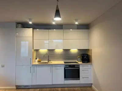 a kitchen with white cabinets and a sink at M27 Apartments in Vilnius