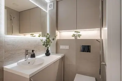 a white bathroom with a sink and a shower at Loft 10 in Vilnius