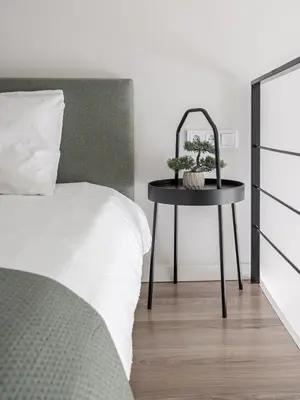 a bedroom with a bed and a table with a mirror at Loft 10 in Vilnius