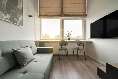 a living room with a couch and two chairs at Loft 10 in Vilnius