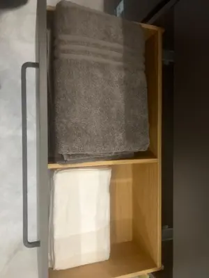 a cabinet with a towel and a roll of towels at Two Bedroom Riverland Apartment in VNO