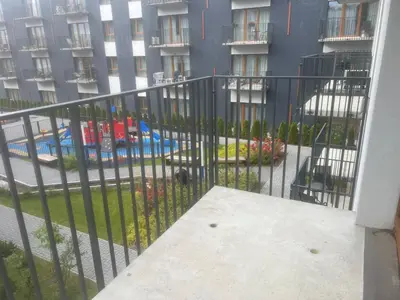 a balcony with a fence in front of a building at Two Bedroom Riverland Apartment in VNO