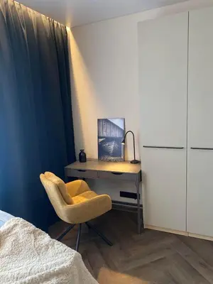 a bedroom with a desk and a chair next to a bed at Two Bedroom Riverland Apartment in VNO