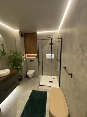 a bathroom with a shower and a toilet and a sink at Two Bedroom Riverland Apartment in VNO
