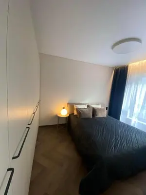 a bedroom with a black bed and a window at Two Bedroom Riverland Apartment in VNO