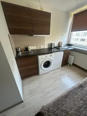 a kitchen with a washing machine and a sink at Little cocoon at border of old city in Vilnius
