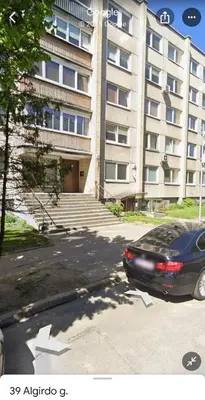a car parked in a parking lot in front of a building at Little cocoon at border of old city in Vilnius