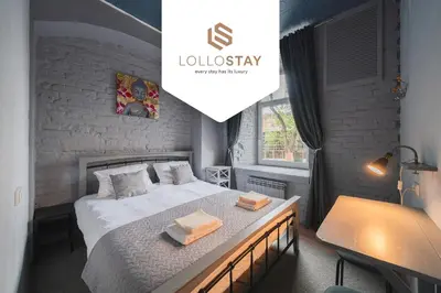 a bedroom with a bed with two towels on it at Sodų 17 Self Check-in - Lollo Stay in Vilnius