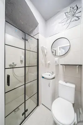 a bathroom with a toilet and a sink and a mirror at Sodų 17 Self Check-in - Lollo Stay in Vilnius