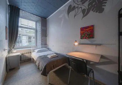 a bedroom with a bed and a desk and a window at Sodų 17 Self Check-in - Lollo Stay in Vilnius