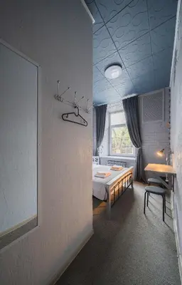 a room with a bed and a table and a window at Sodų 17 Self Check-in - Lollo Stay in Vilnius