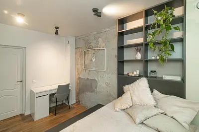 a bedroom with a bed and a desk in it at Cozy flat in Vilnius Old Town in Vilnius