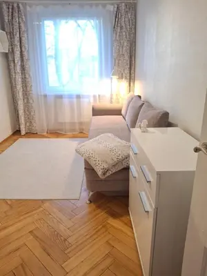 a living room with a couch and a window at Angel Apartment near city centre in Vilnius