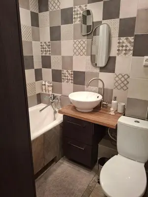 a bathroom with a sink and a toilet and a tub at Angel Apartment near city centre in Vilnius