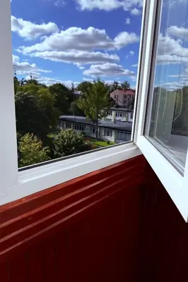 a window with a view of a city at Feliz Stay in Šiauliai