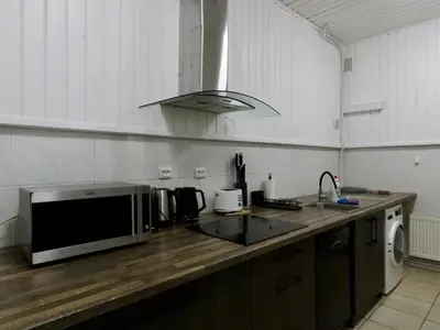 a kitchen with a microwave on a wooden counter at Kauno Marių Vilos in Samylai