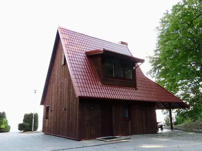 a wooden barn with a red roof at Kauno Marių Vilos in Samylai