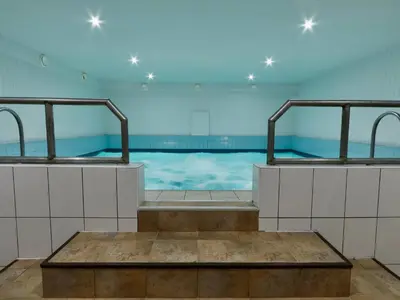 a swimming pool with two sinks in a room at Kauno Marių Vilos in Samylai
