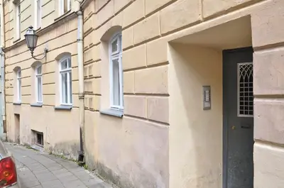 a building with a door on the side of a street at 2 bedroom old town apartment with parking in Vilnius