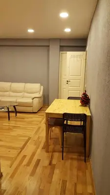 a living room with a table and a couch at 2 bedroom old town apartment with parking in Vilnius