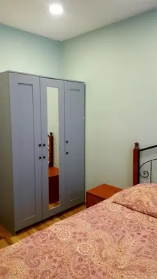 a bedroom with a bed and a mirror at 2 bedroom old town apartment with parking in Vilnius